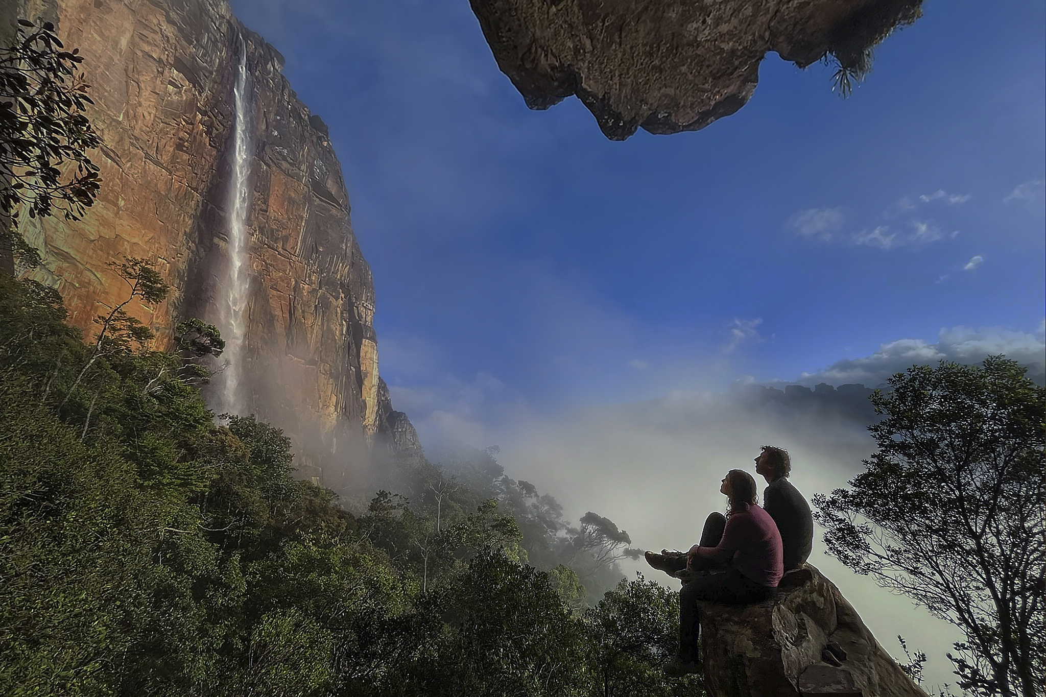 Travelers on the summit gazing across the canyon at Angel Falls